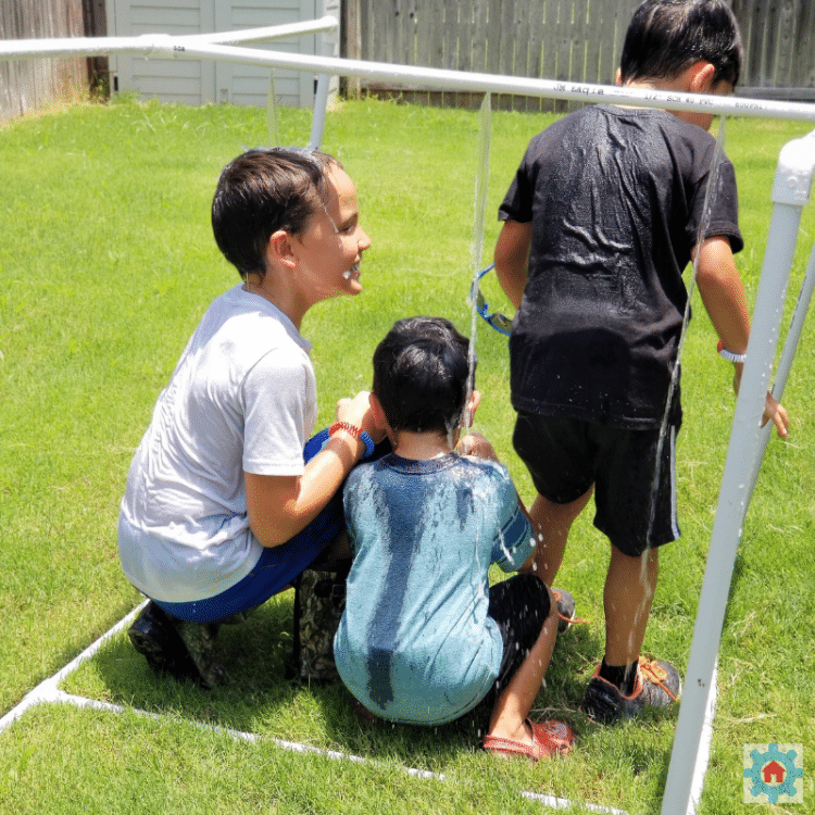 kids playing in water flow experiment activity outside