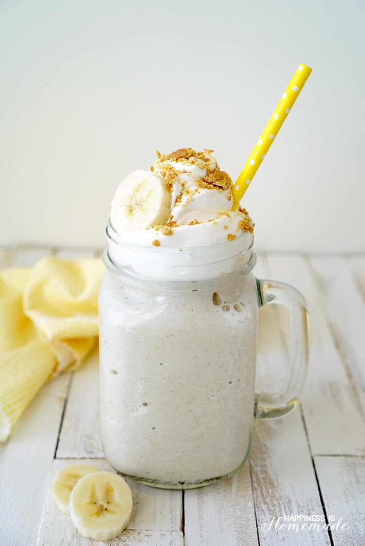 a banana smoothie in a mason jar with a yellow straw