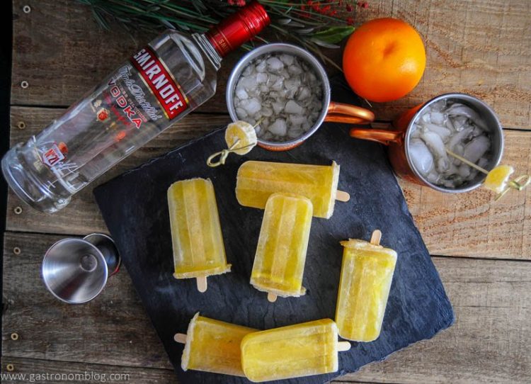 orange moscow mule popsicles with drinks and fruit