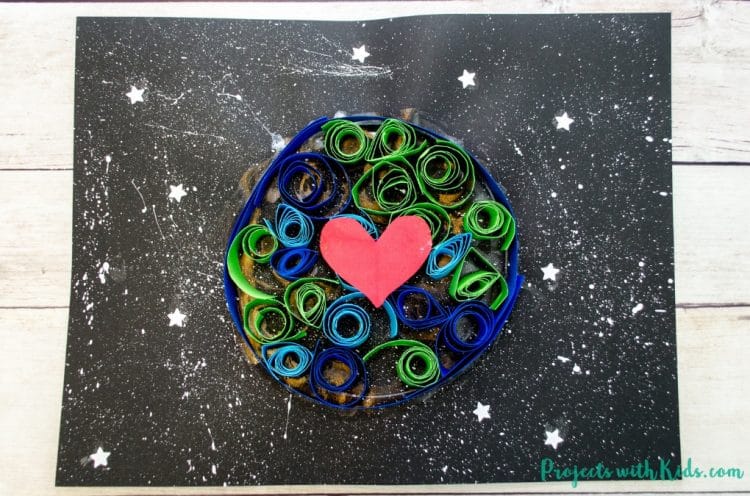 paper quilled to make an earth with a heart
