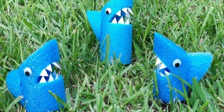 Pool Noodle shark crafts in the grass 