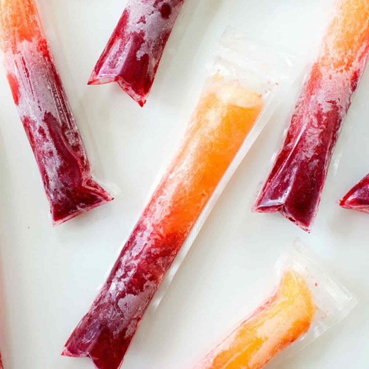 raspberry peach prosecco popsicles in plastic wrap