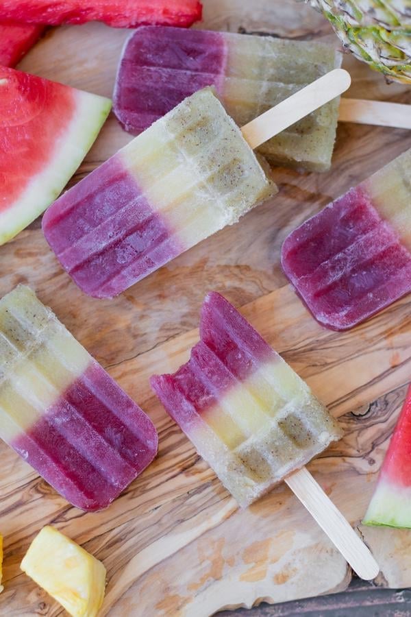 yummy watermelon wine popsicles on wooden table with fruit