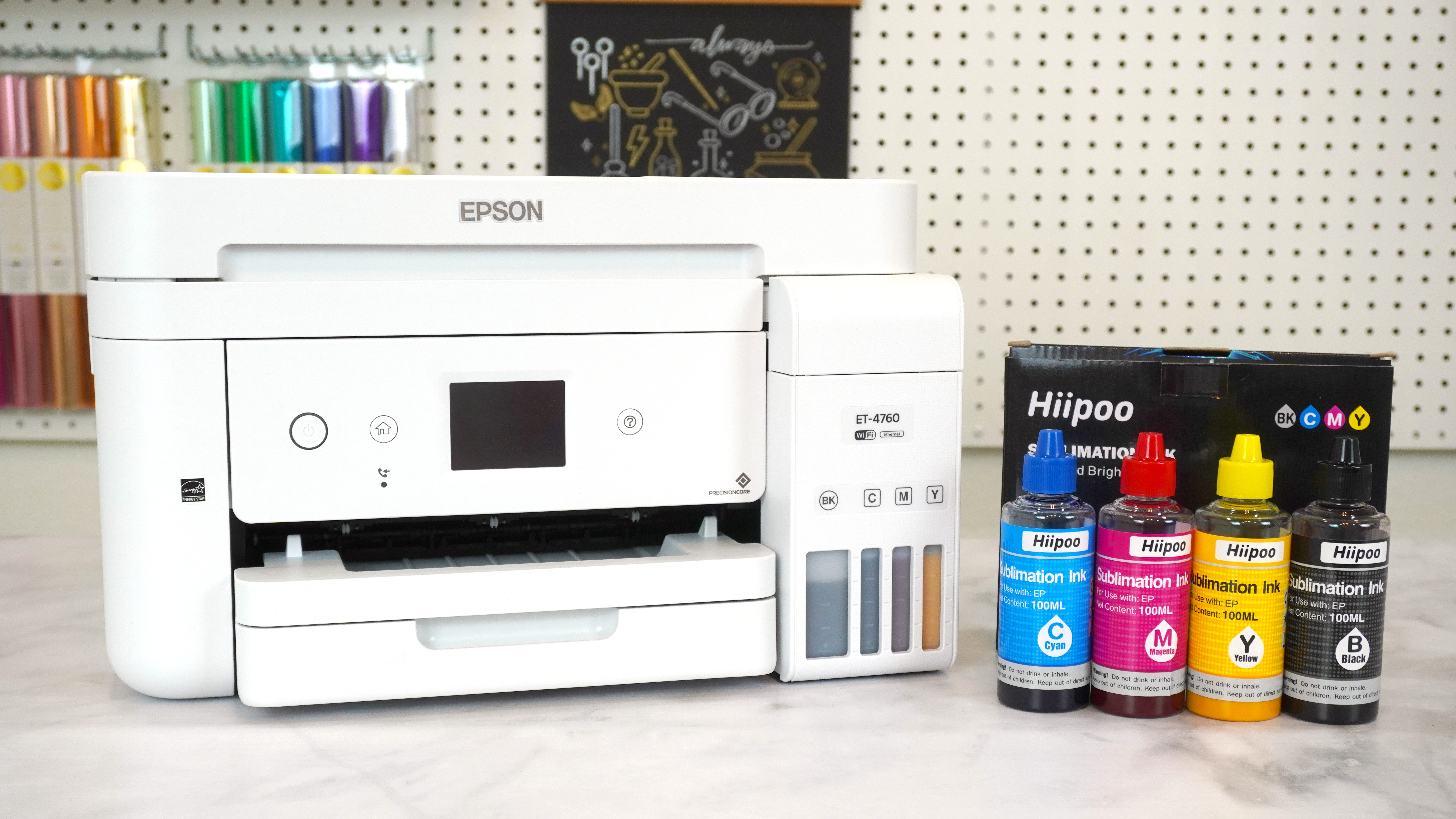 Epson EcoTank ET-4760 printer on table with bottles of cyan, magenta, yellow, and black Hiipoo sublimation ink