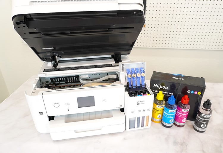 Epson EcoTank printer with lid and tanks open and Hiipoo sublimation ink bottles