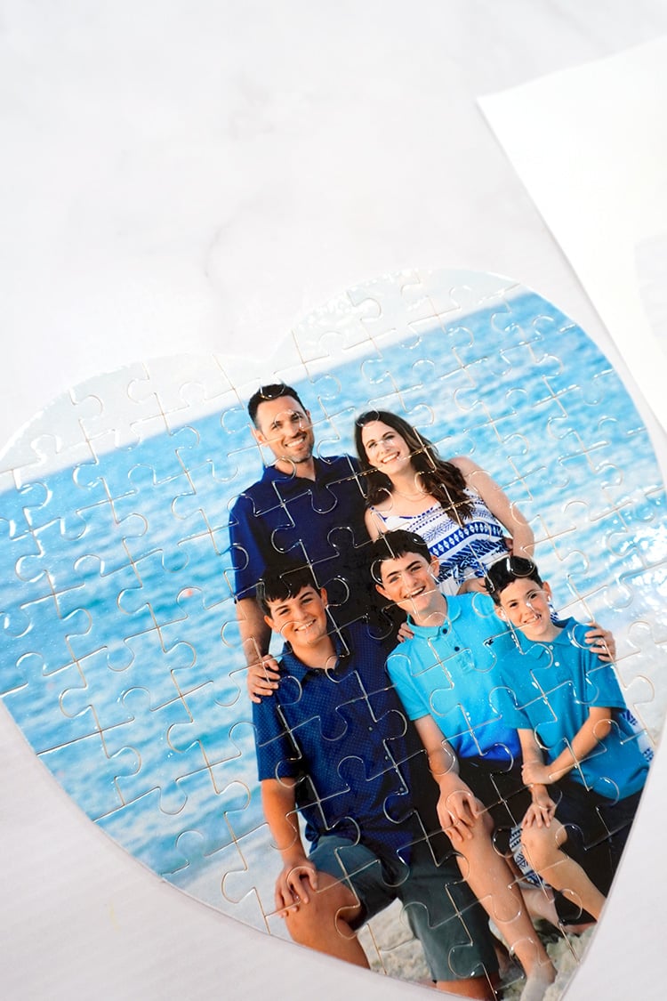 Vibrantly colored family photo puzzle on marble background