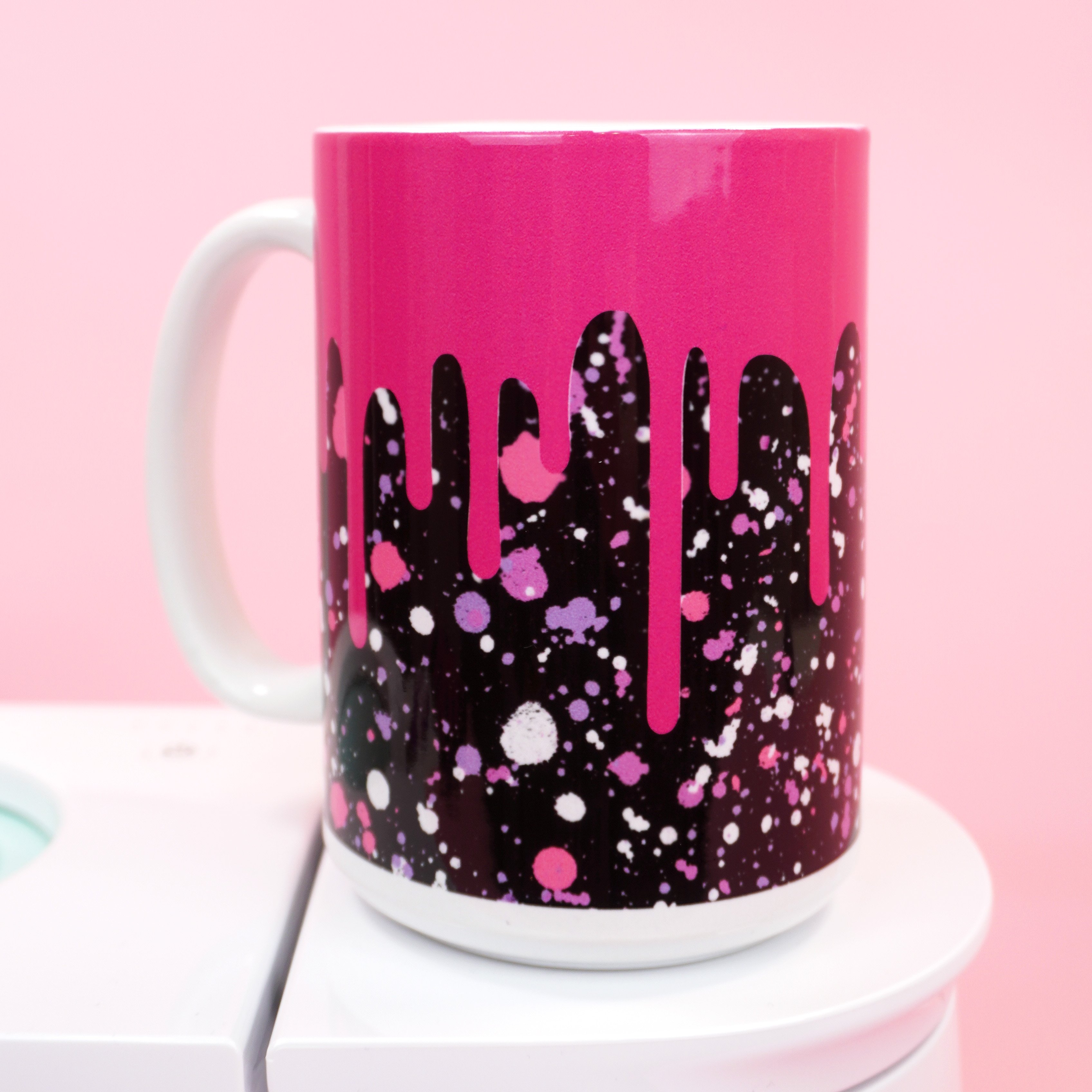 Pink and black "paint splattered" and "drippy" mug made with Infusible Ink