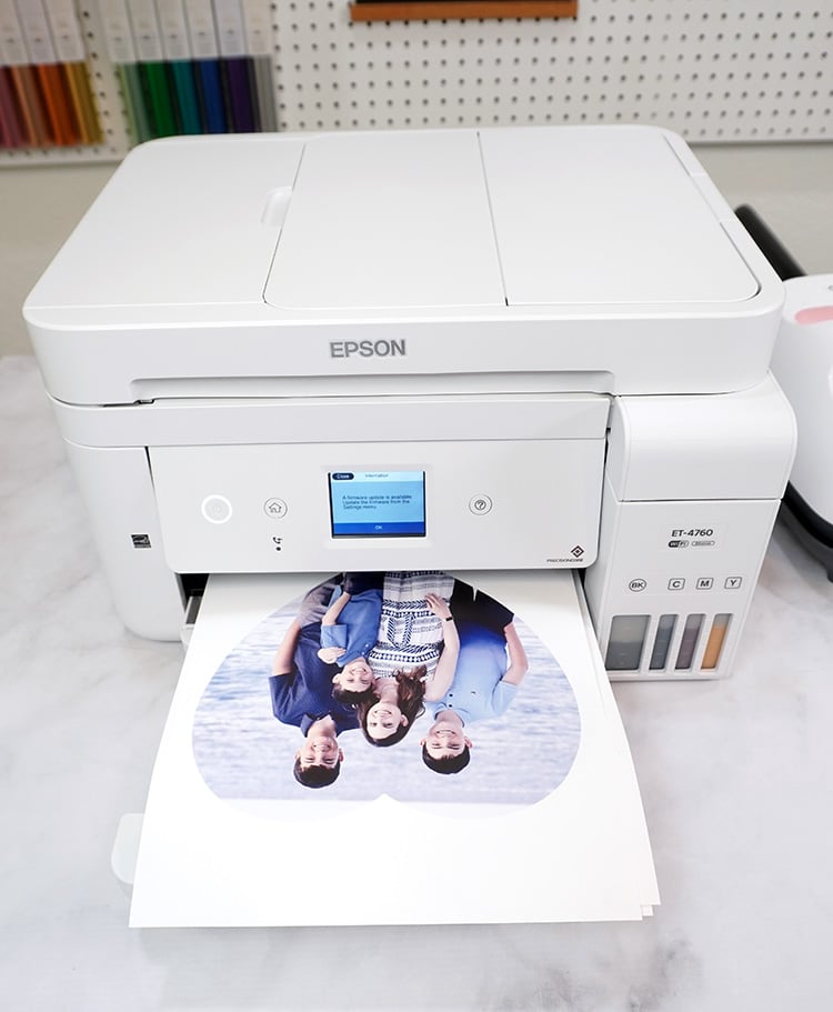 Epson EcoTank 4760 printer on desk with photo in printer tray