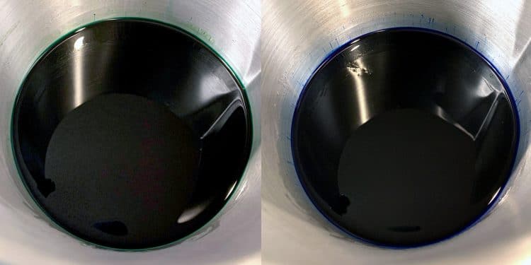 Green and blue wax melted in stainless steel pitchers
