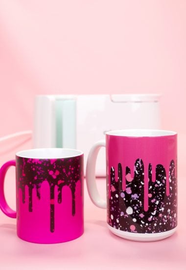 Two "Drippy" pink and black mugs with the Cricut Mug Press