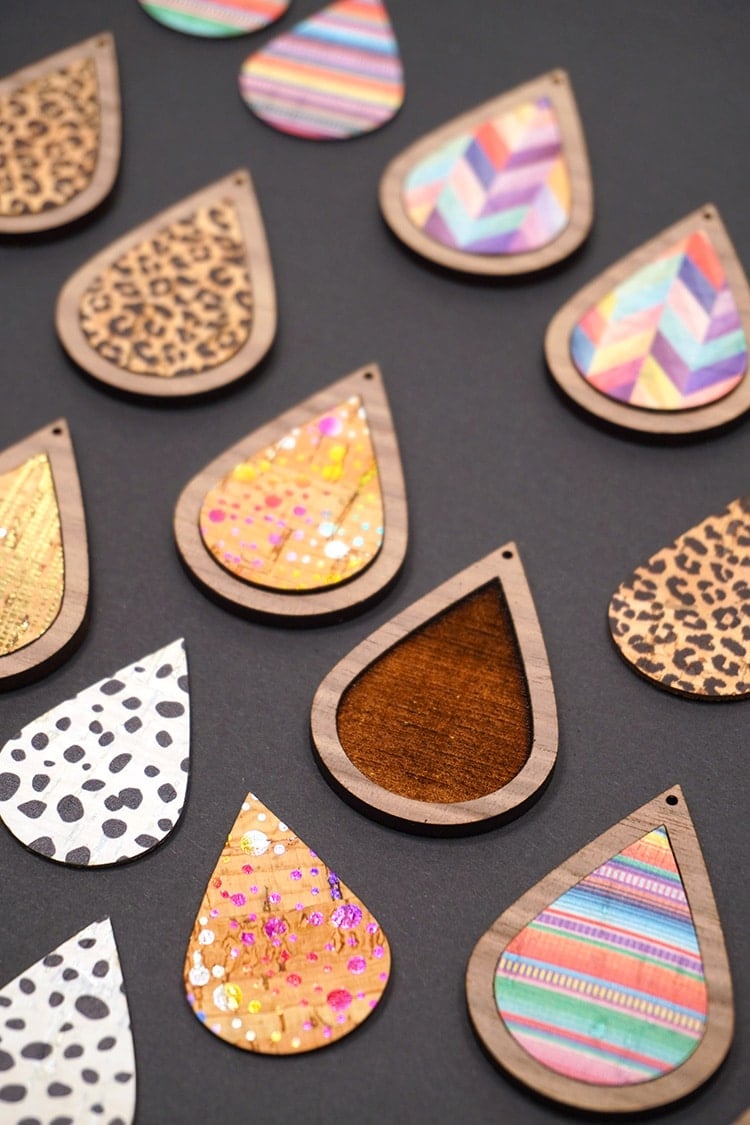 Close up of colorful teardrop shaped cork and wood pieces on a black background
