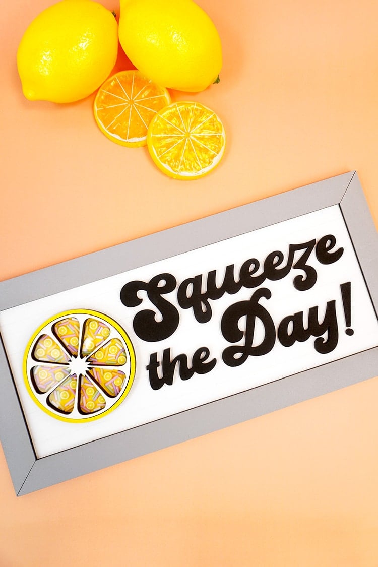 Squeeze the Day Lemon Sign on orange background with lemons