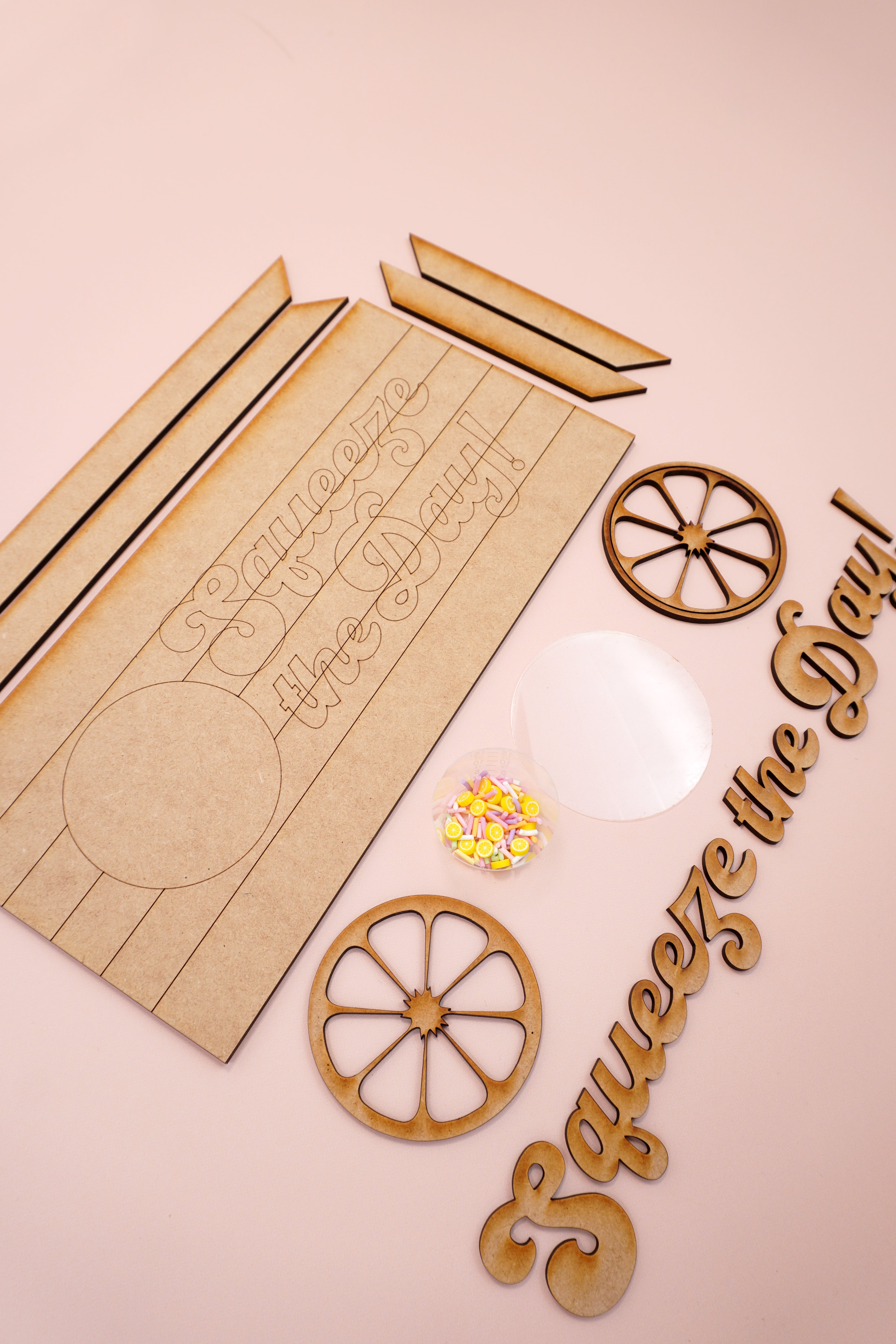 Squeeze the Day laser cut sign pieces on peach background