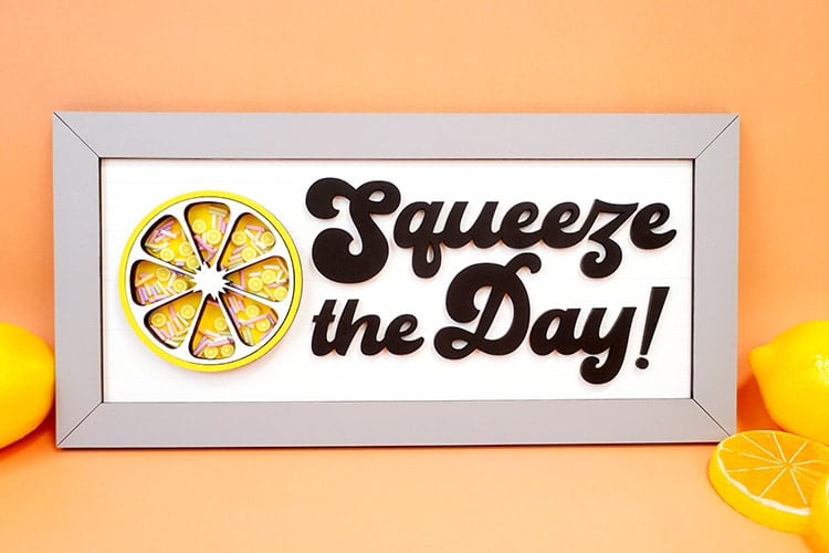 Squeeze the Day laser cut wood sign with shaker embellishments on orange background