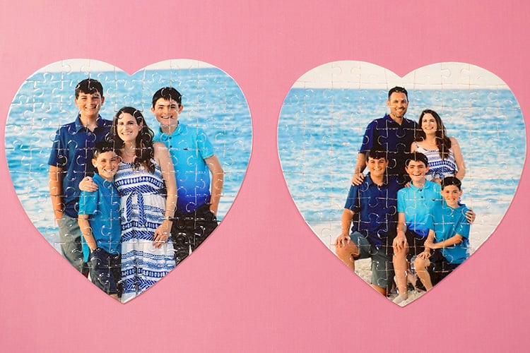two heart-shaped photo jigsaw puzzles on pink background