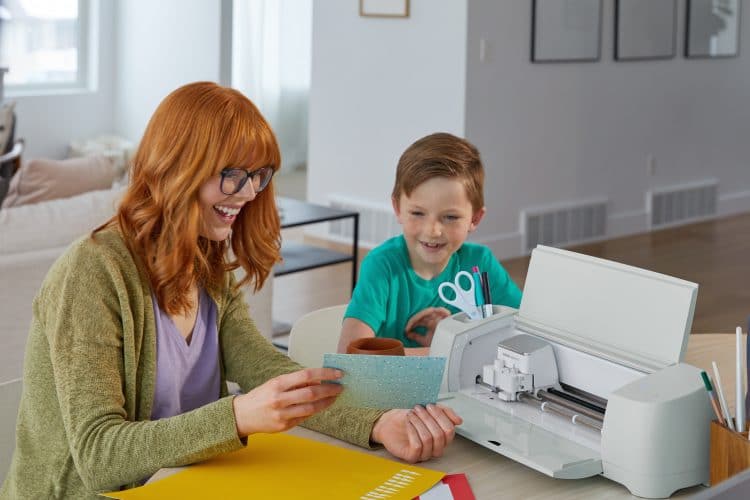 White woman and boy making cards with Cricut Explore 3