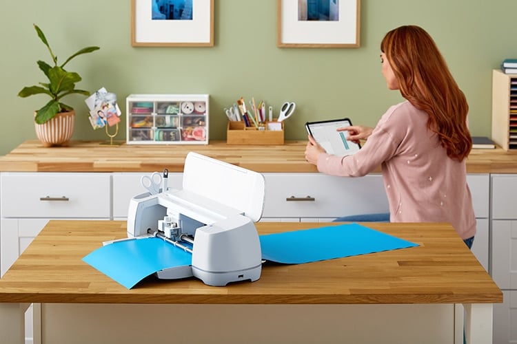 women using tablet with cricut make 3 on table