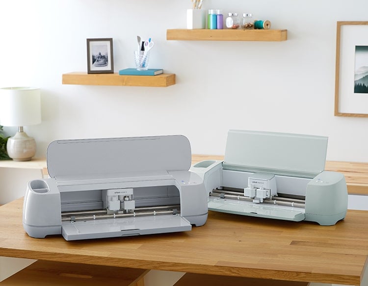 Cricut Maker 3 and Cricut Explore Air 3 Machines on wood work table