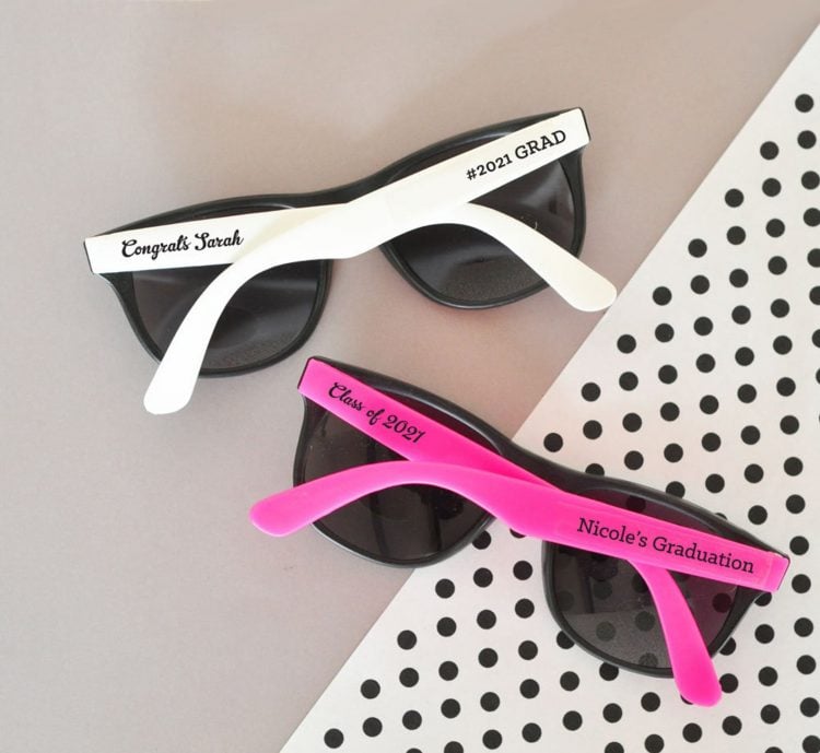 two sunglassess with customized words with names and graduation dates