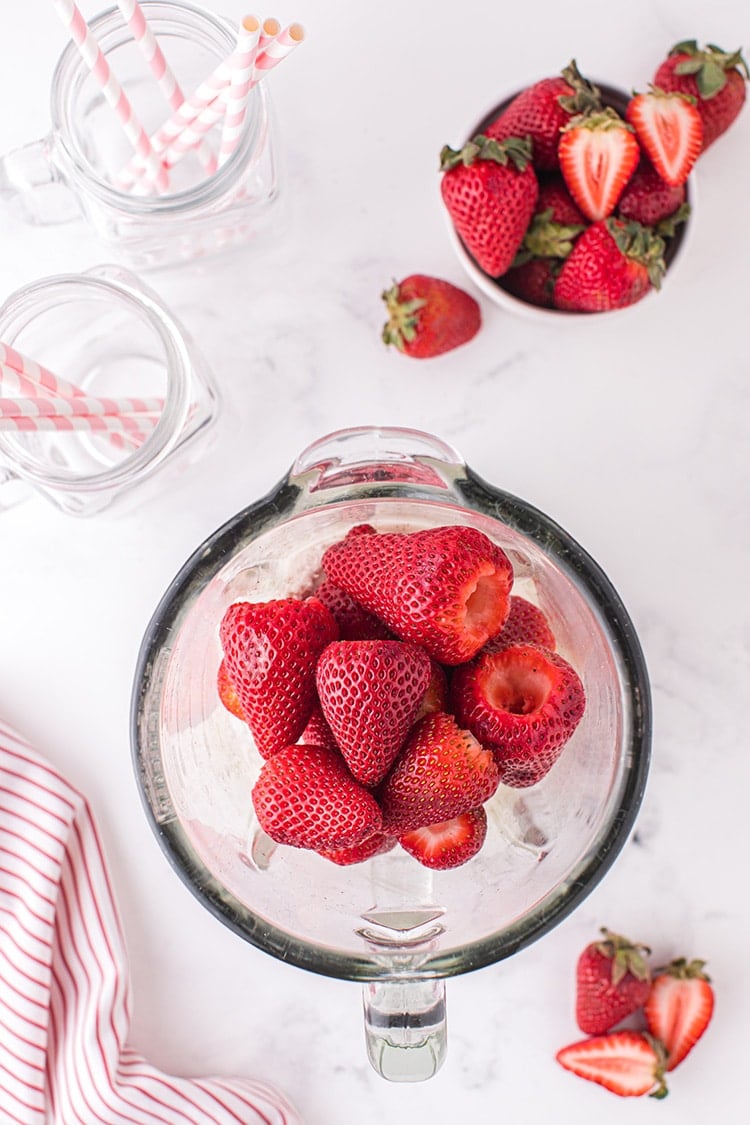 Overhead view of strawberries in glass blender