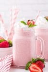 Strawberry milkshake with whipped cream and strawberry garnish