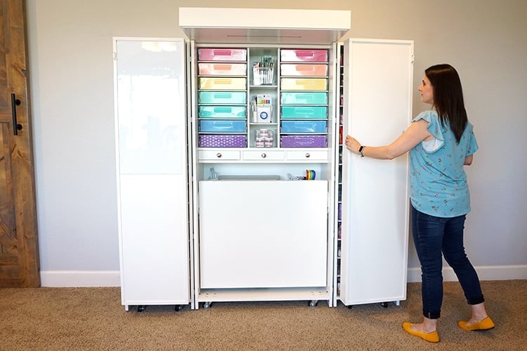 girl closing dreambox with labeled bins and organized supplies