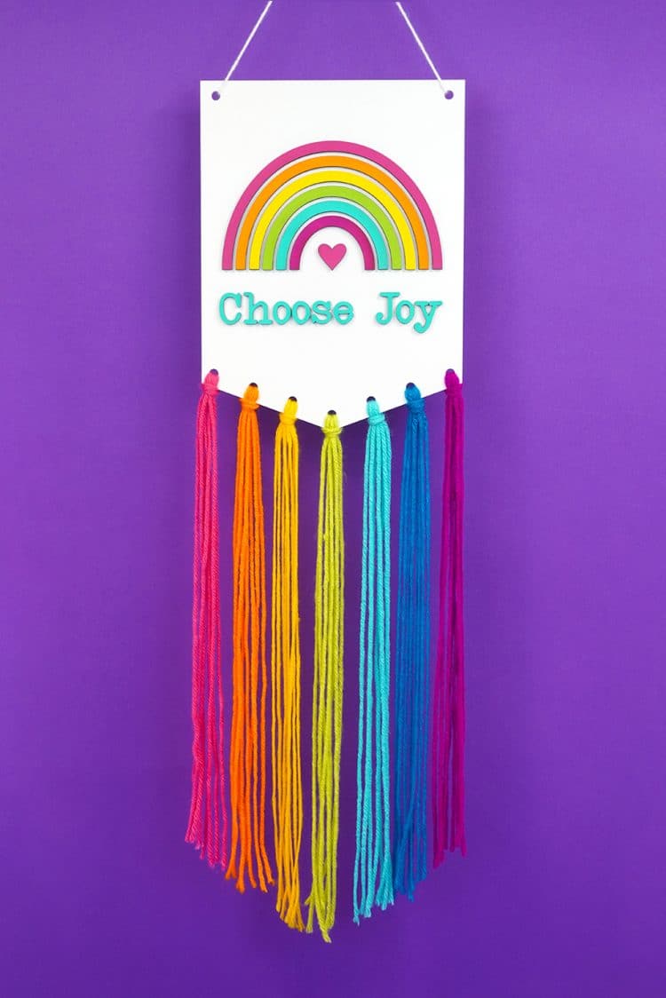 Rainbow Macrame Wall Hanging on purple background