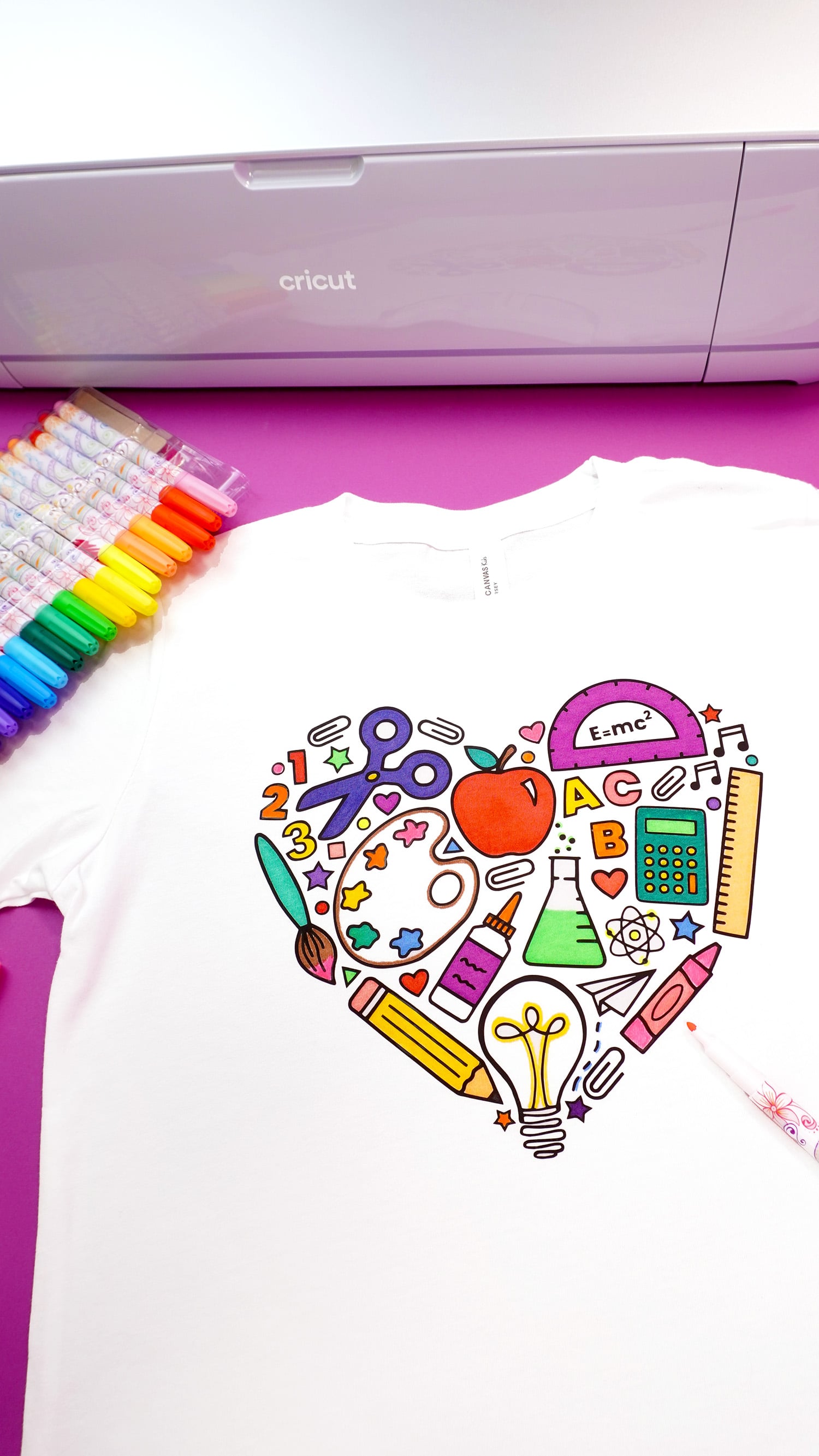 Back to school coloring shirt on a purple background with fabric markers and Cricut Maker 3