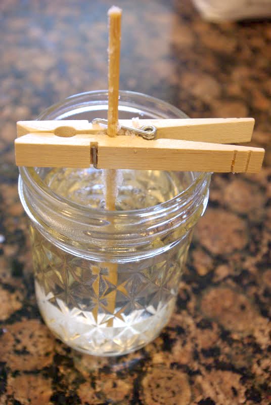 overhead view of clothespin holding a wooden skewer in place atop a mason jar