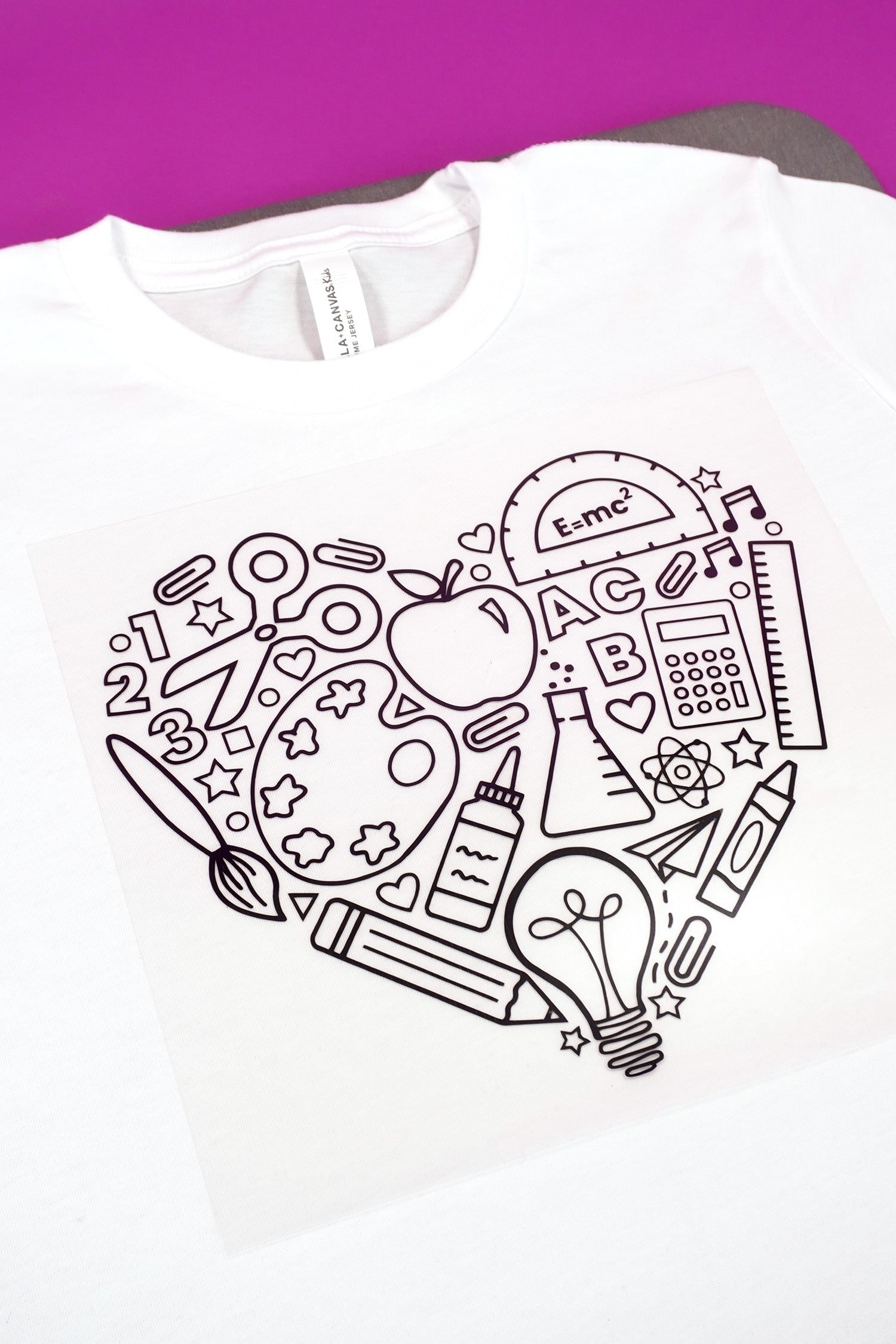 Close up of back to school iron-on design on white shirt
