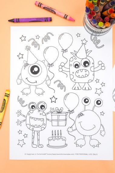 Monster coloring page with birthday party theme on an orange background with crayons