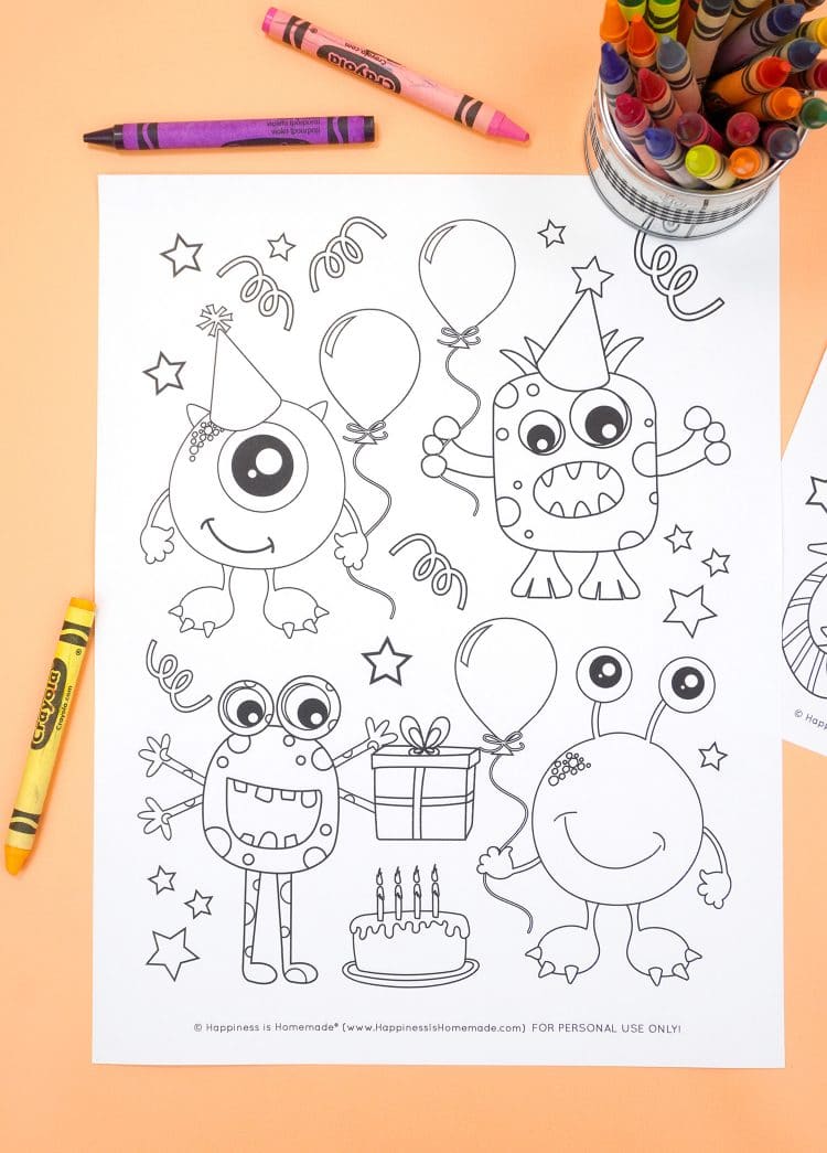 Monster coloring page with birthday party theme on an orange background with crayons