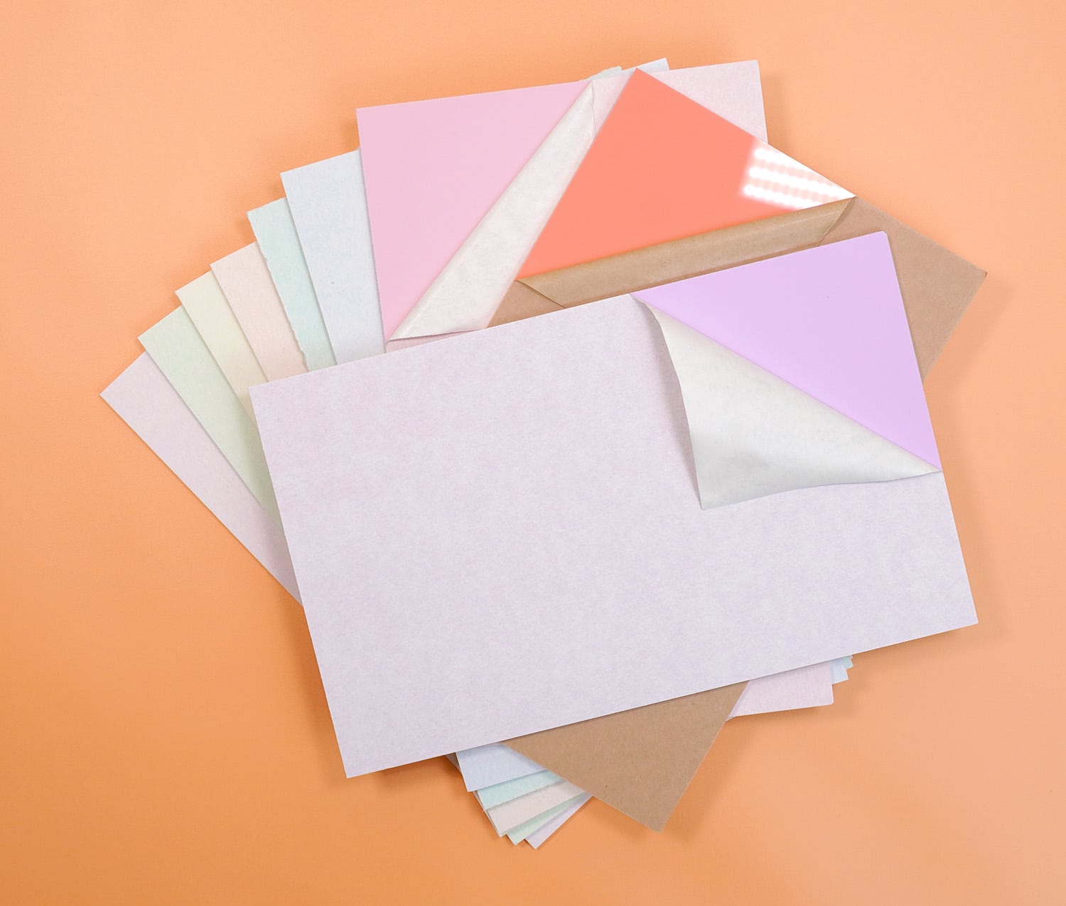 Pastel rainbow colored acrylic sheets on an orange background
