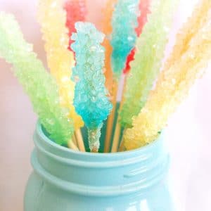 colorful rock candy sticks in an aqua mason jar