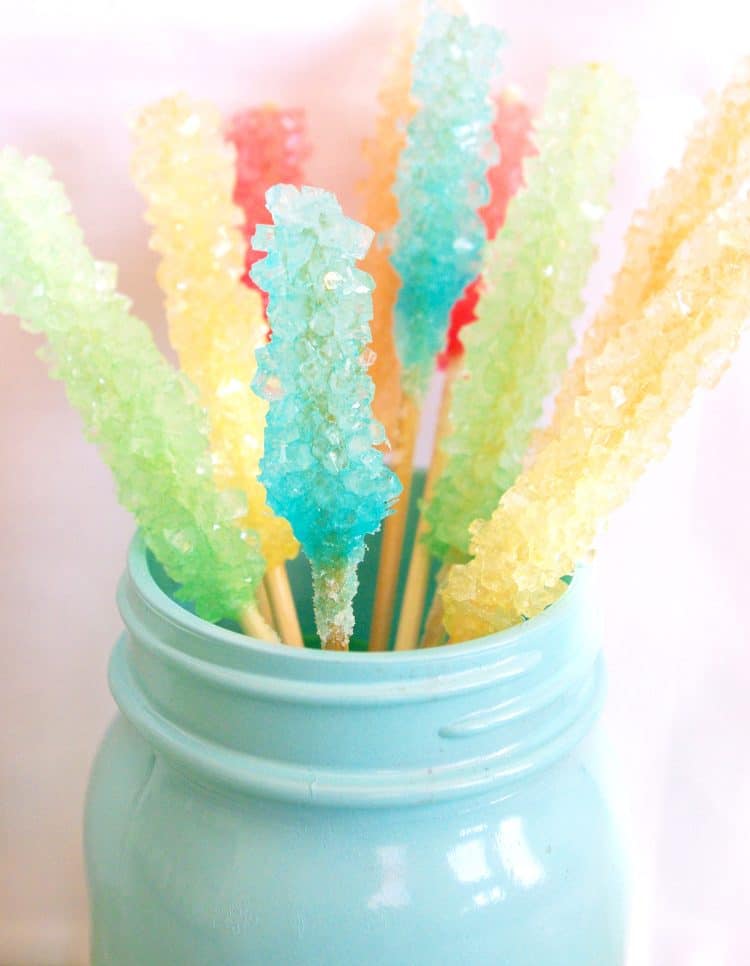 colorful rock candy sticks in an aqua mason jar