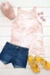 Blush pink tie-dye tank top and baseball hat made with avocado dye staged with an outfit on a white background