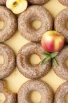 apple cider donuts with apples on yellow background