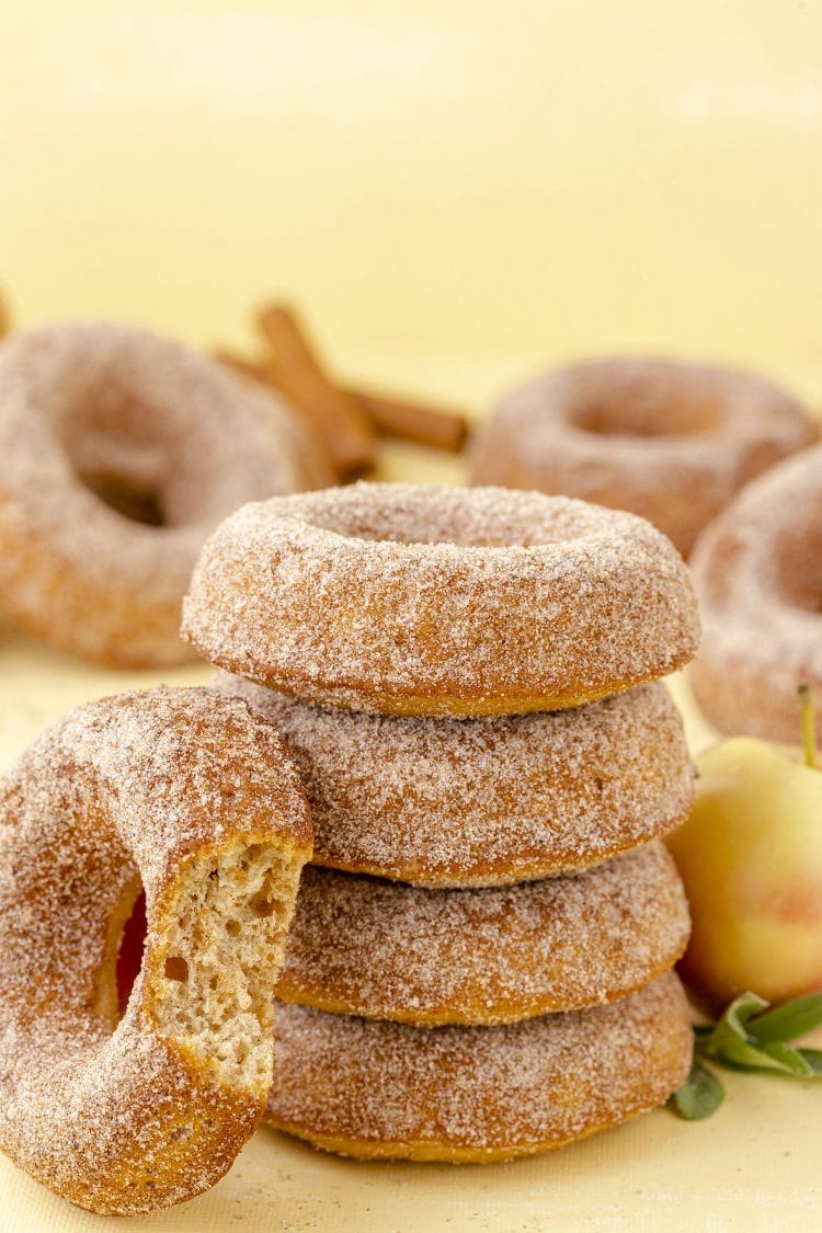 stack of apple cinnamon apple cider donuts on yellow background