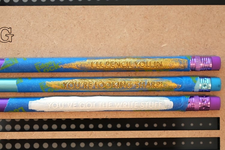 Close up of engraved pencils with masking tape and paint