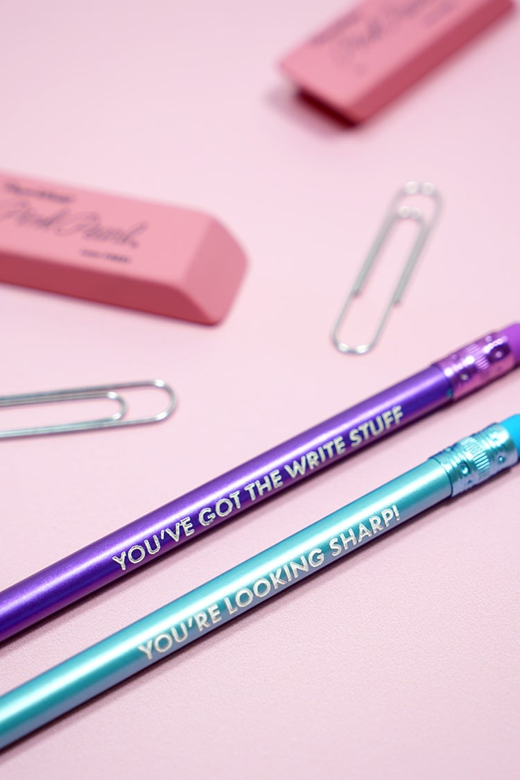 Purple and blue engraved pencils with "You're Looking Sharp" and "You've Got the Write Stuff"