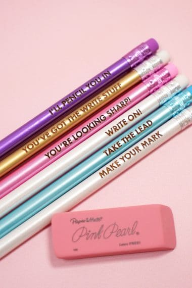 Colorful engraved pencils on a pink background with Pink Pearl eraser