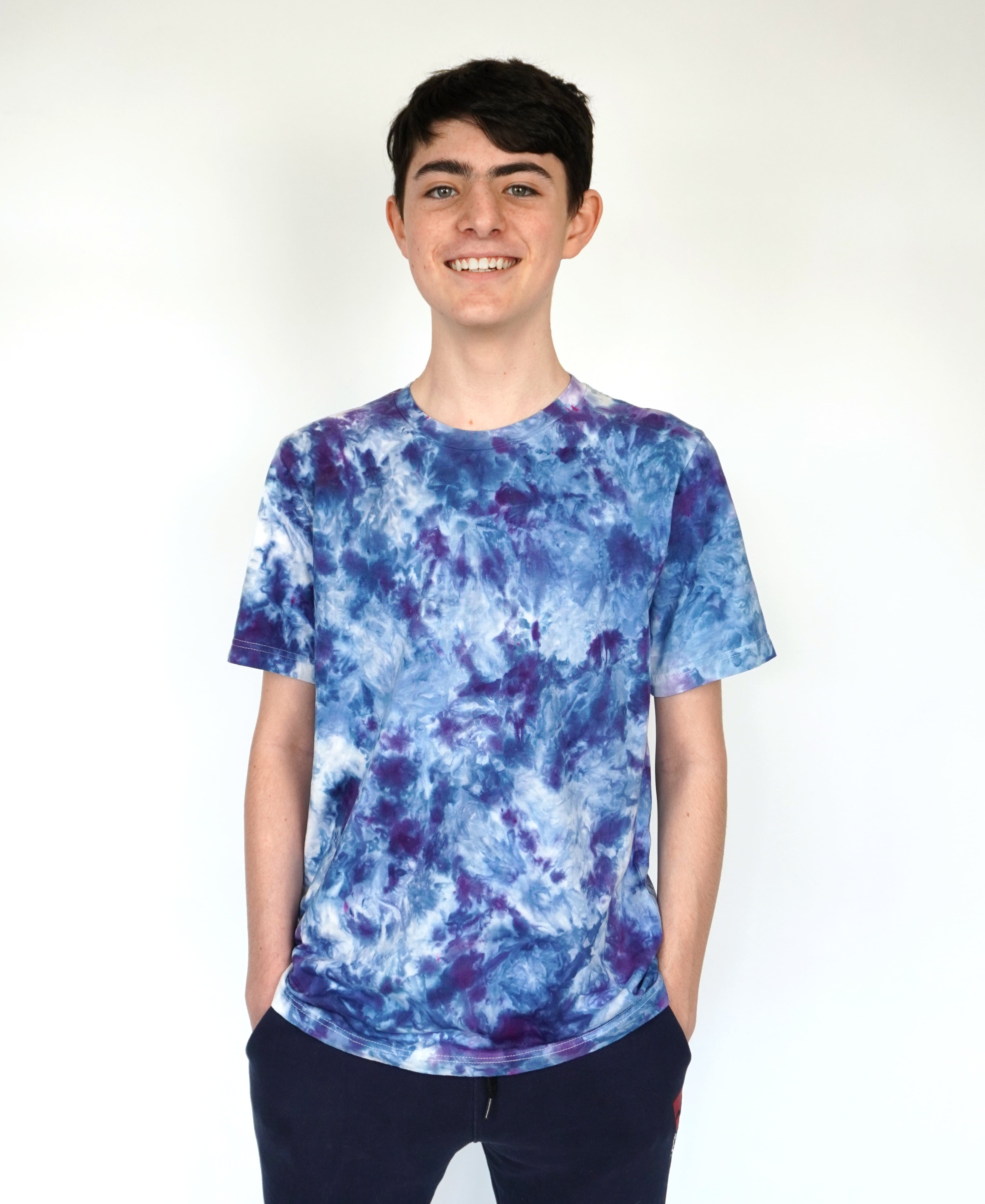 young boy modeling tie dyed blue shirt