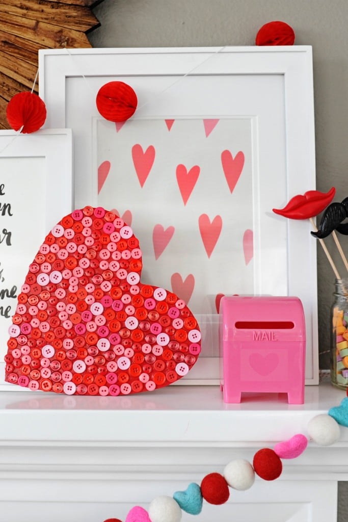 heart made from buttons and tiny pink mailbox on mantel