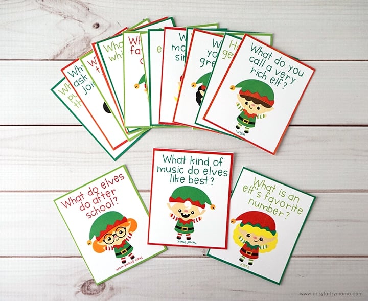 Printable elf jokes with pictures of elves on note cards on white wood background