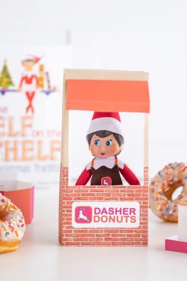 Elf on the shelf doll with donuts and donut shop window prop