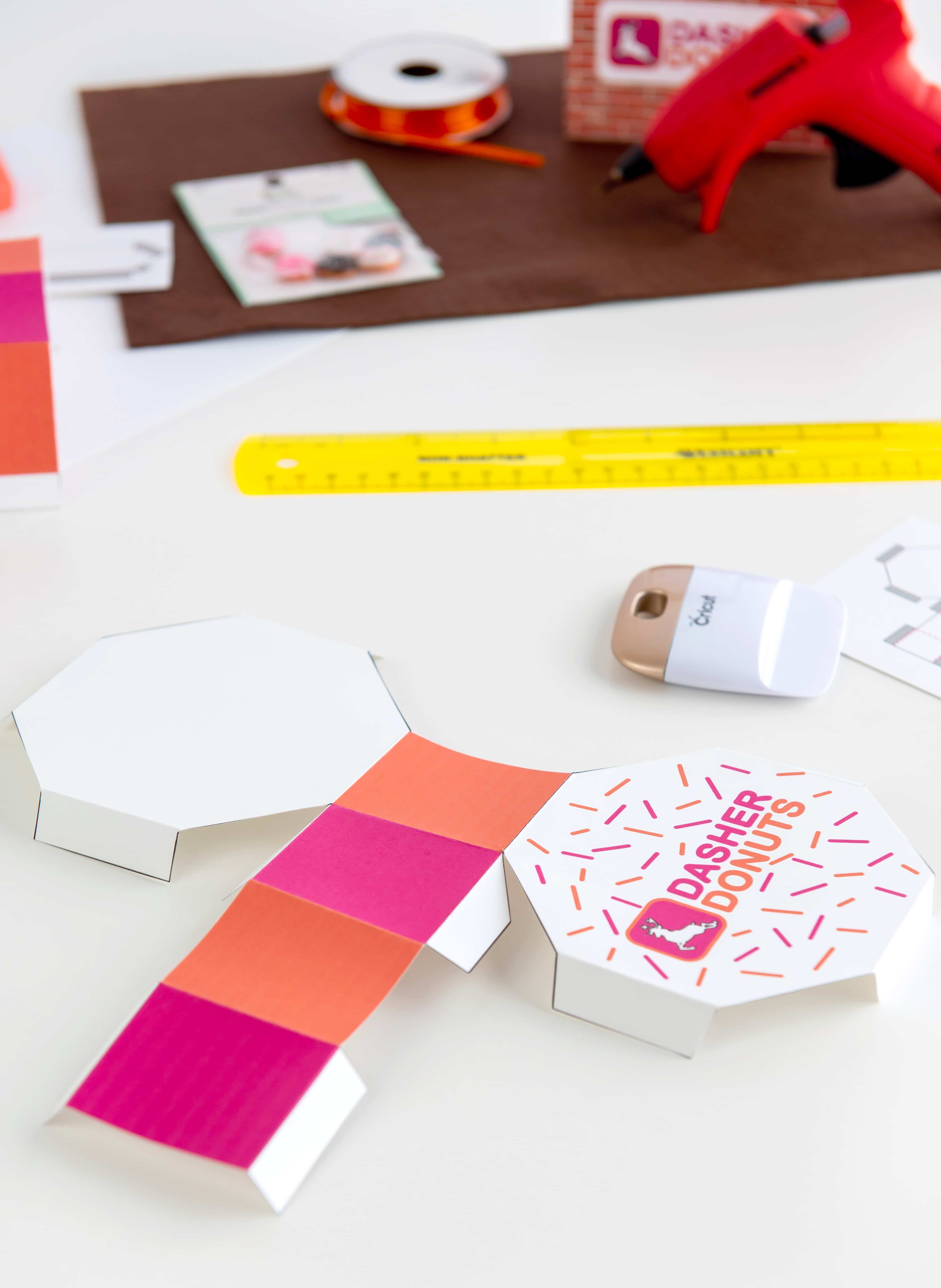 Assembly of a printable Dasher Donuts doughnut box on a white background