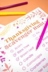 Close up of words "Acorn, Bare Tree, Brown Leaf, Candle" etc. on a printable Thanksgiving Scavenger Hunt game on orange background