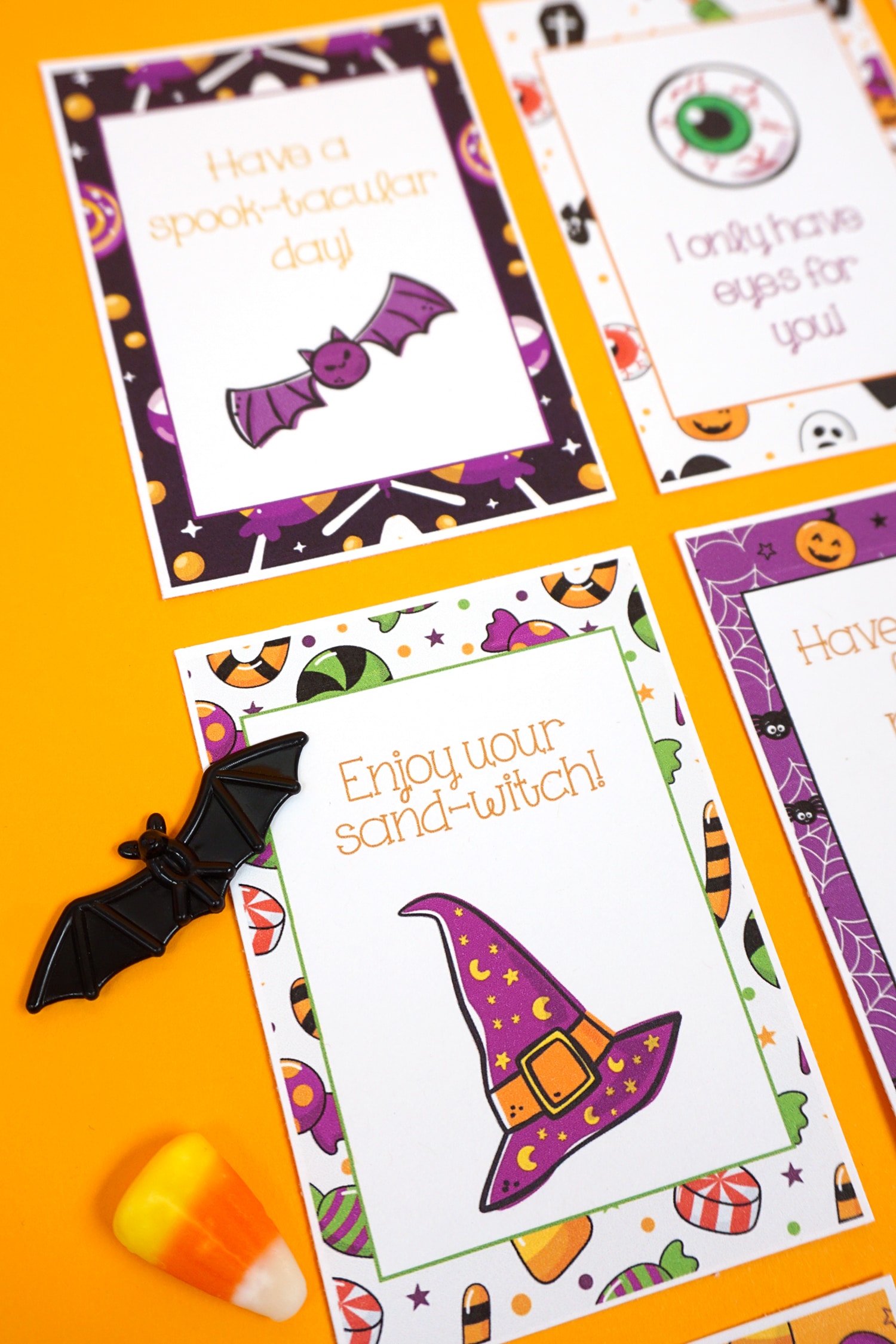 Close up of "Enjoy your sand-witch" Halloween lunch note on orange background