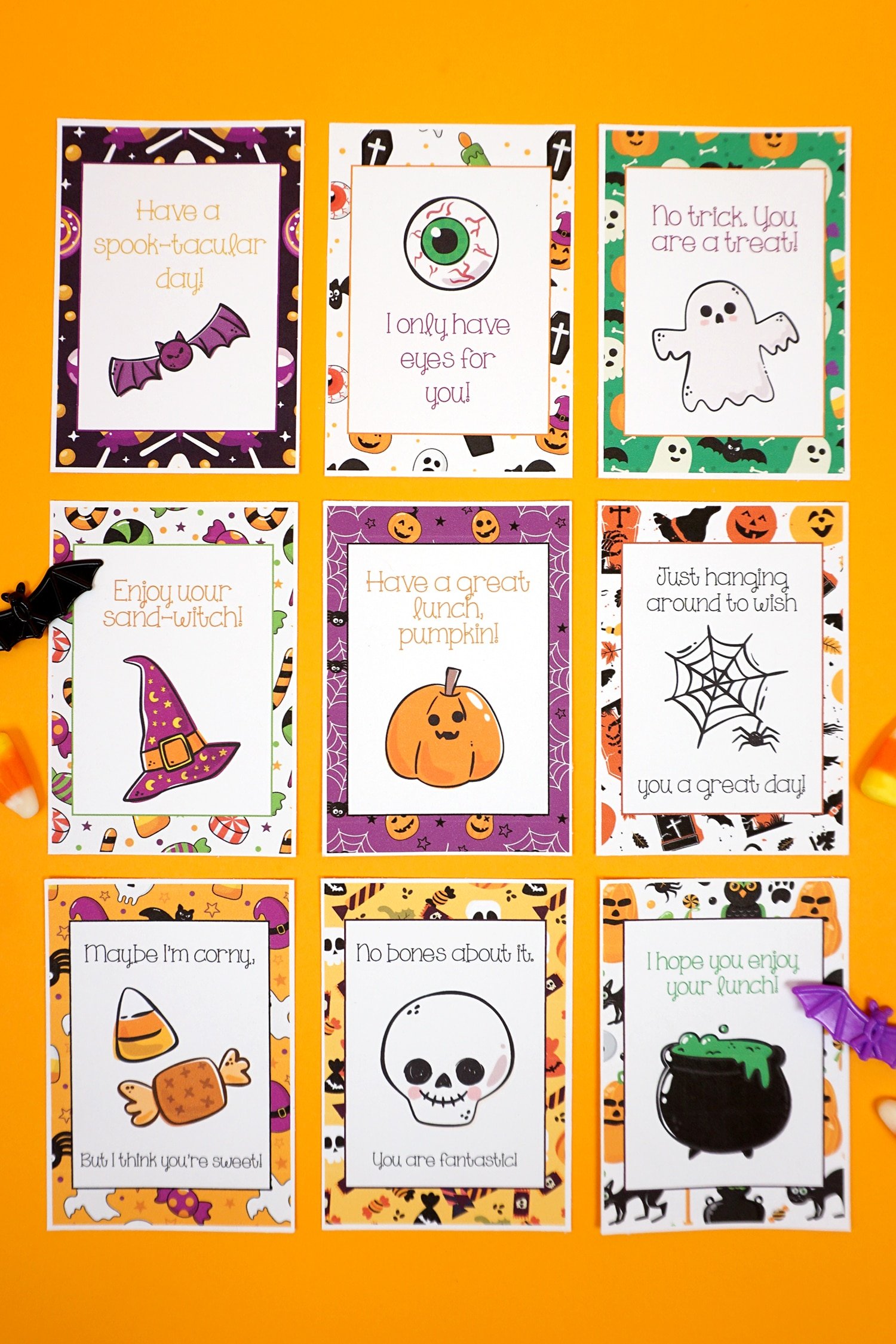 Halloween lunch notes arranged in a grid on an orange background with candy corn and batd