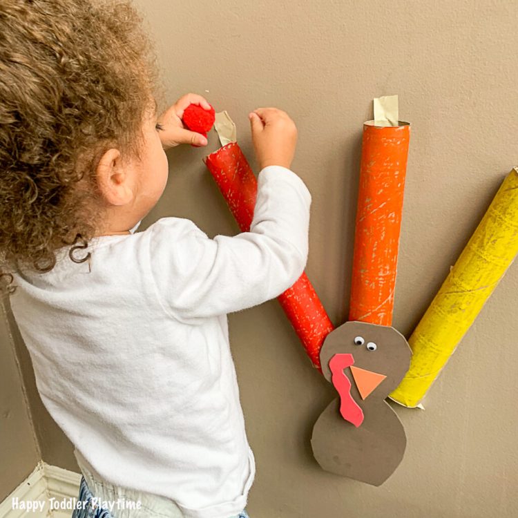 toddler playing with turkey drop game